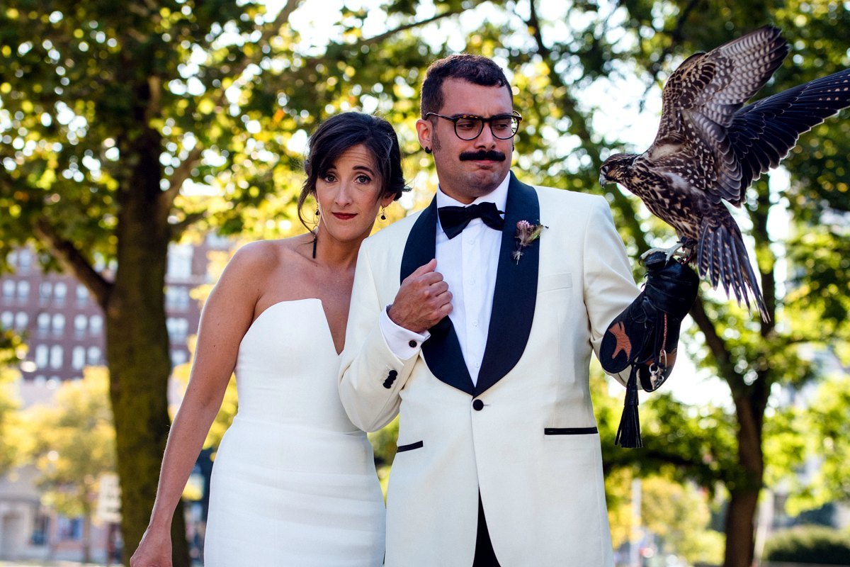 Wedding couple posing with an ambassador raptor