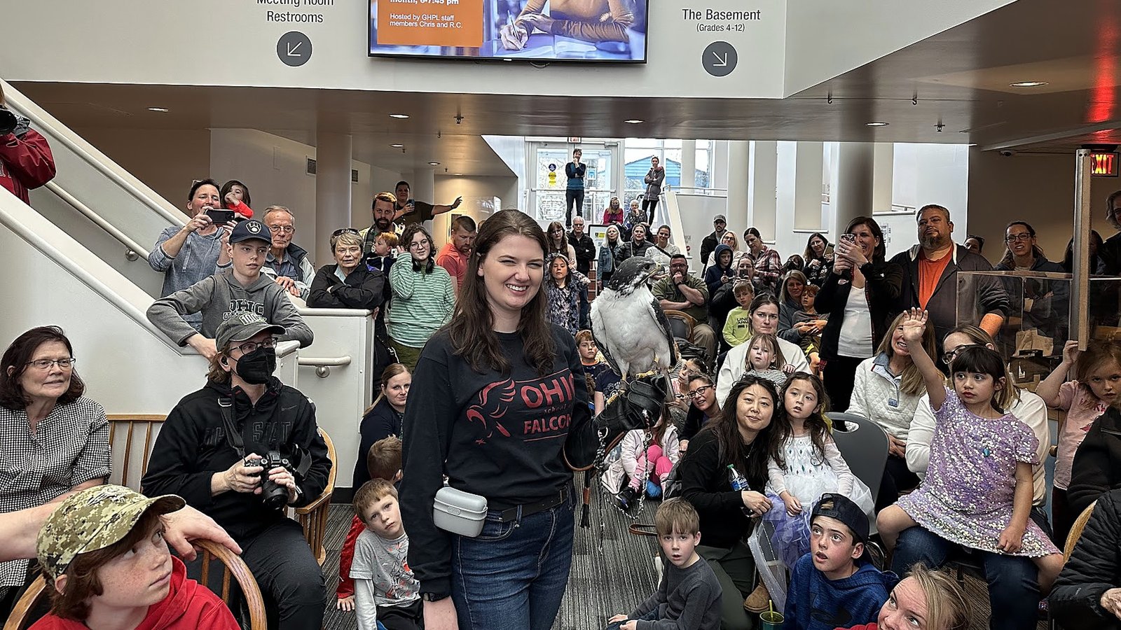 Ohio School of Falconry educator presenting to a large public education audience